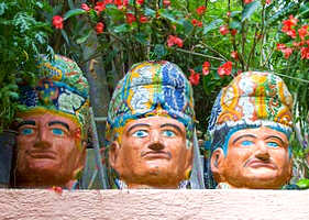 Huge ceramic masks adorn the gardens of the home of Toller Cranston in San Miguel de Allende