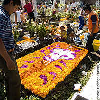 Mexican grave decorated with marigolds for Day of the Dead