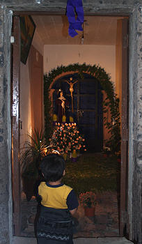 Boy admiring a home altar for the Virgen de Sorrows, Holy week, Mexico